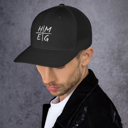 Angled view of black HMEG Christian trucker hat showing embroidered front design