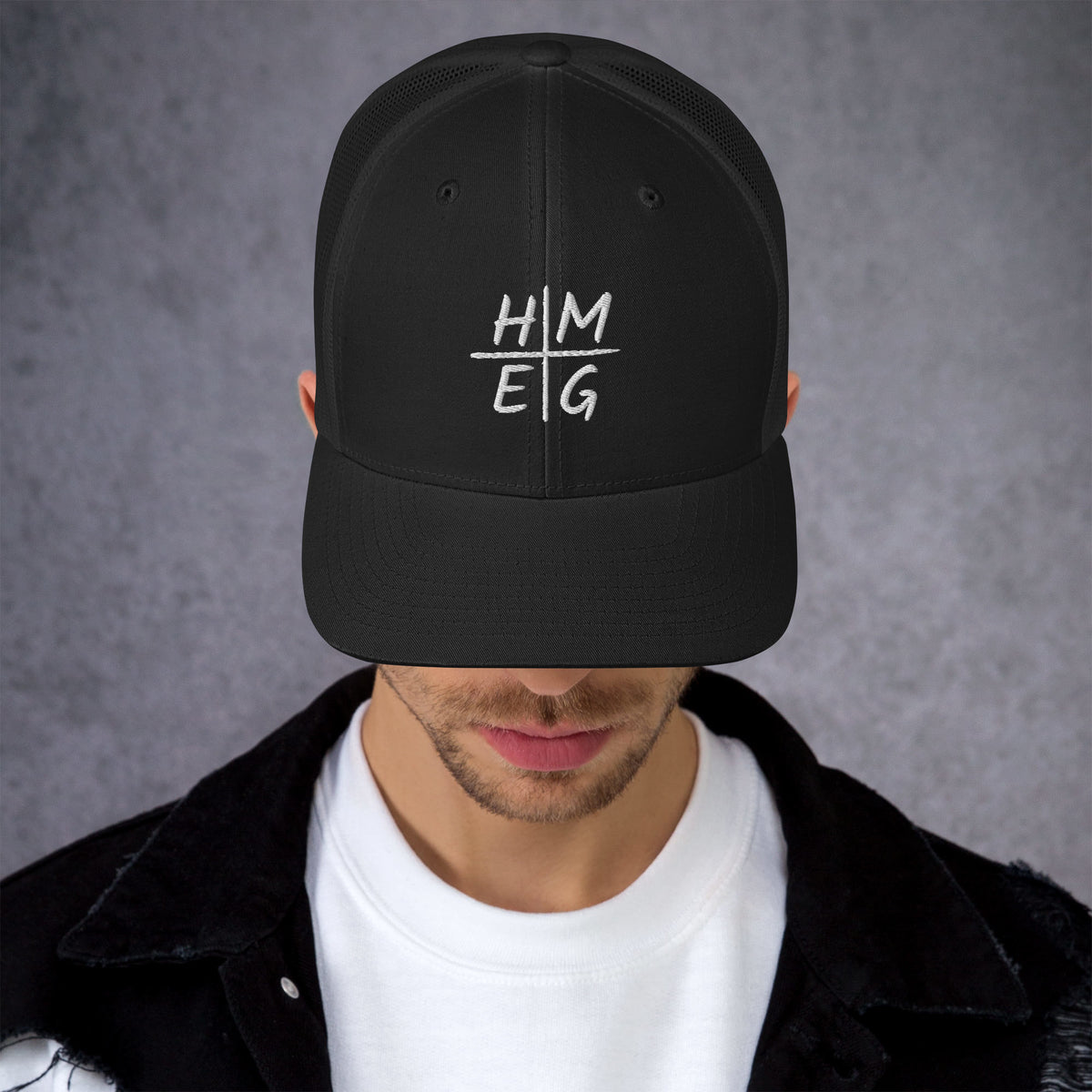 Front view of black HMEG embroidered Christian trucker hat