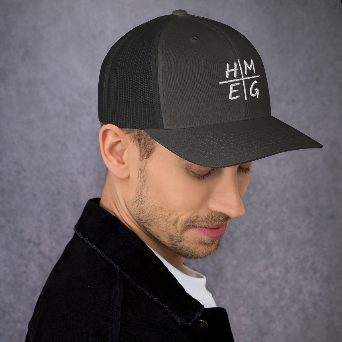 Charcoal and black HMEG embroidered Christian trucker hat