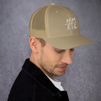 Khaki HMEG embroidered Christian trucker hat shown on a model