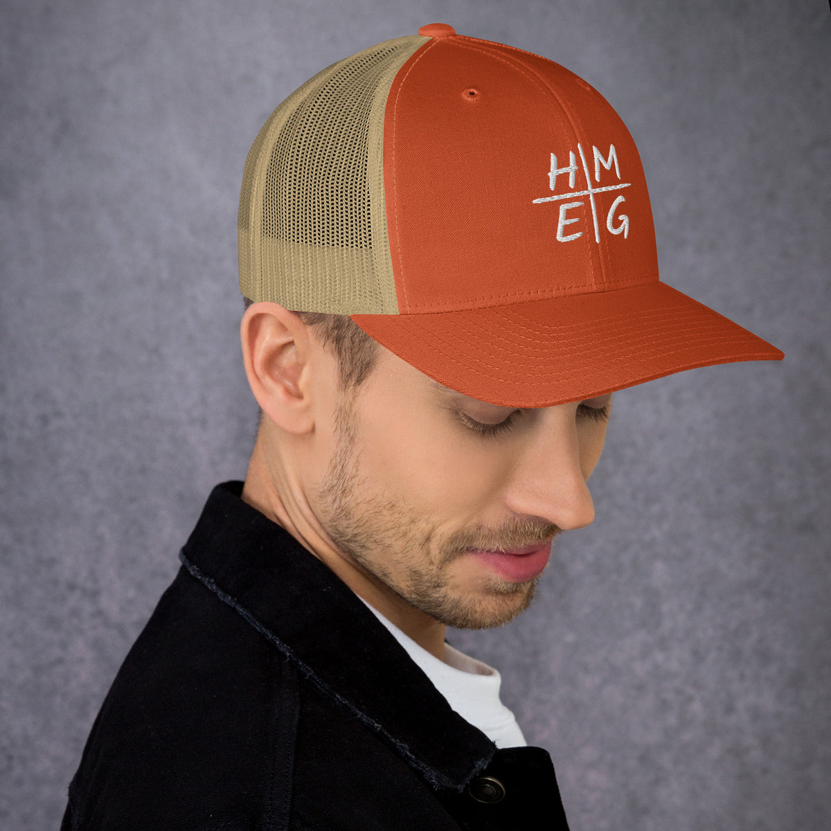 Rustic orange and khaki HMEG embroidered Christian trucker hat