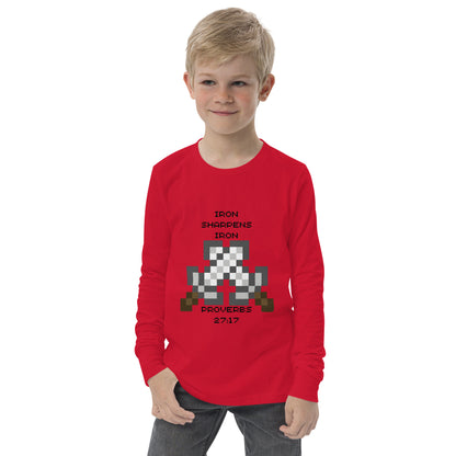 Boy wearing red Iron Sharpens Iron Christian youth long sleeve shirt with pixel-art swords inspired by Proverbs 27:17
