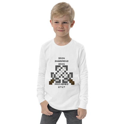 Boy wearing white Iron Sharpens Iron Christian youth long sleeve shirt featuring Proverbs 27:17 pixel-art design