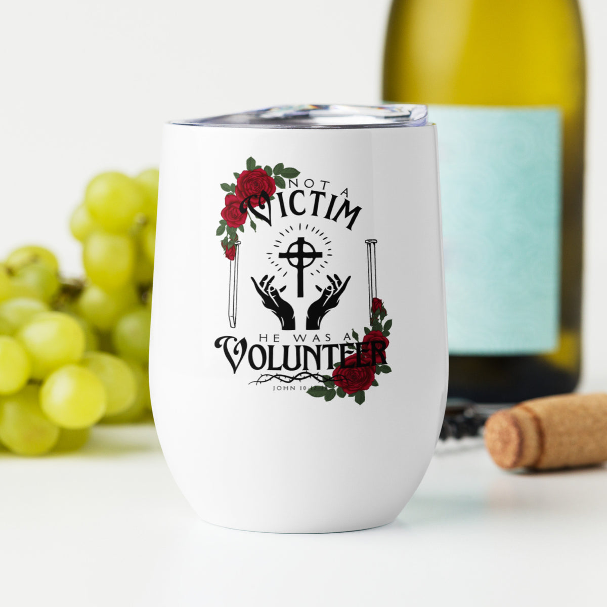 White Not a Victim Christian wine tumbler displayed beside green grapes