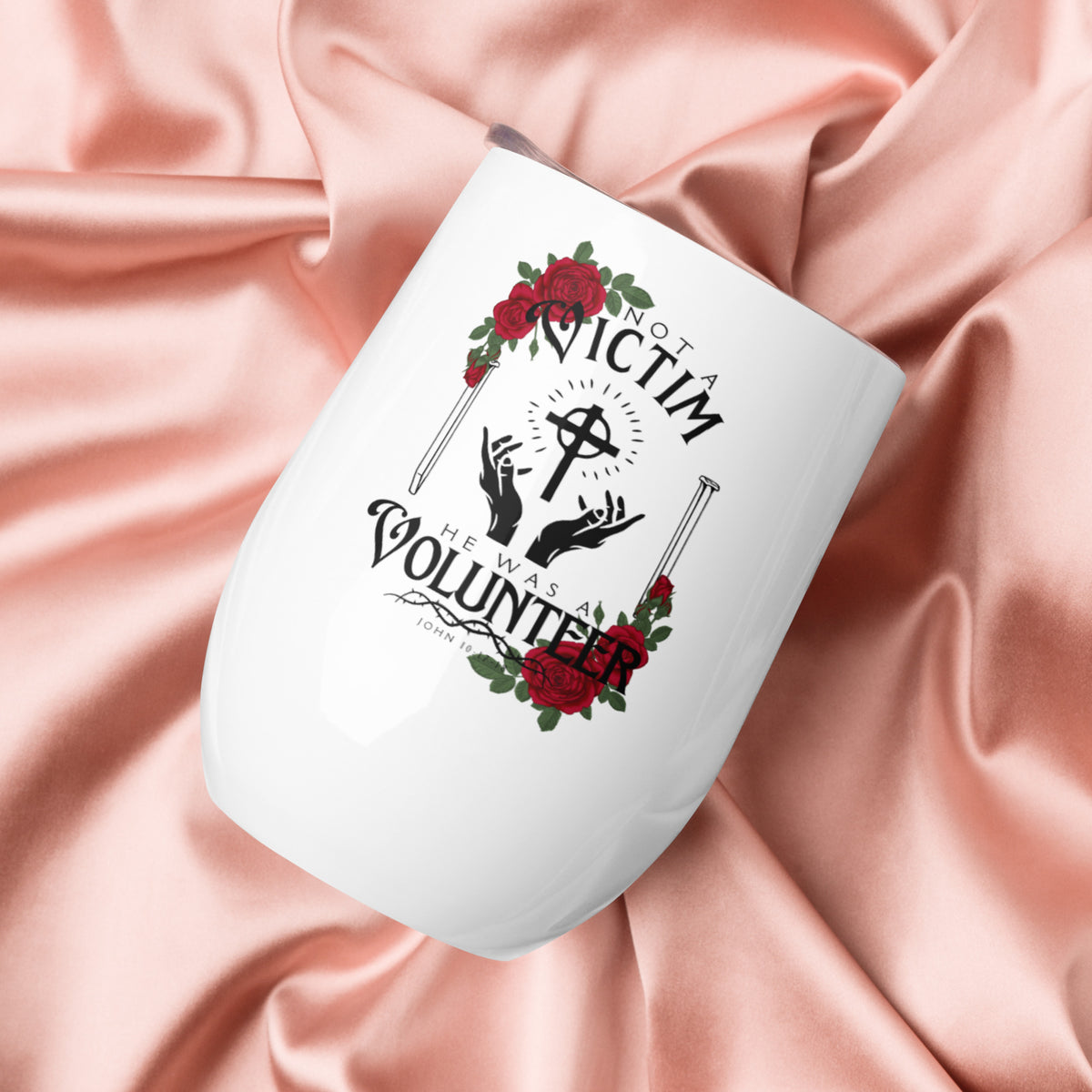 White Not a Victim Christian wine tumbler held against pink clothing