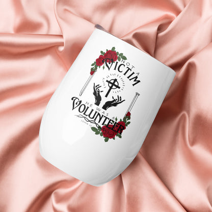 White Not a Victim Christian wine tumbler held against pink clothing